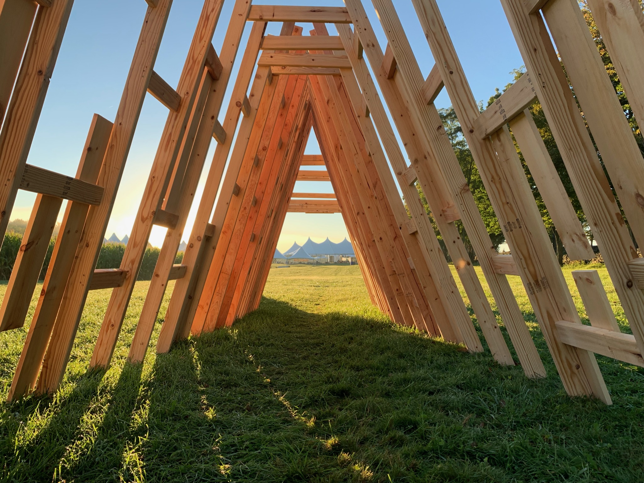 A camera view inside a triangular wood sculpture.