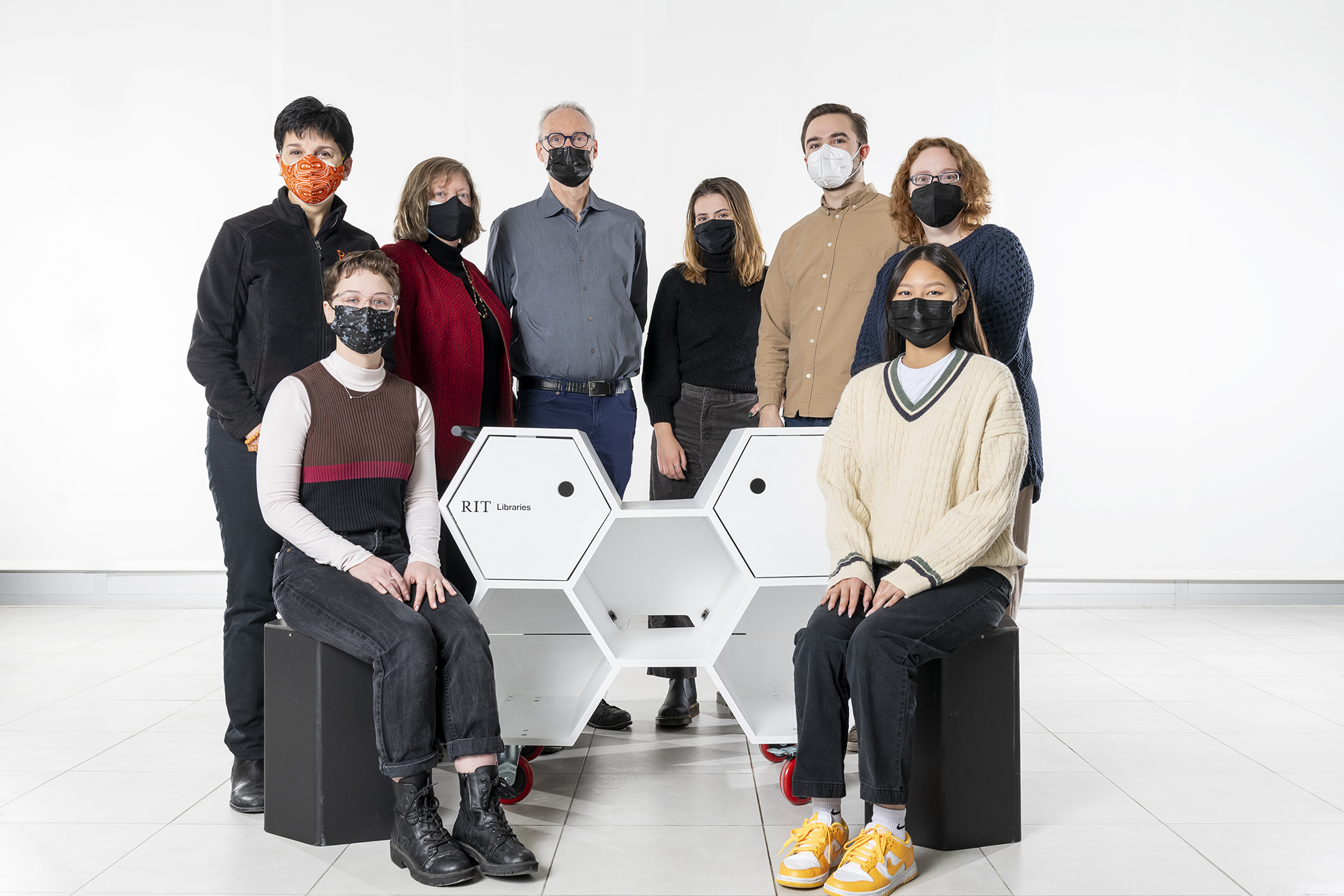 A group of designers and librarians gather around their Hexacart design.