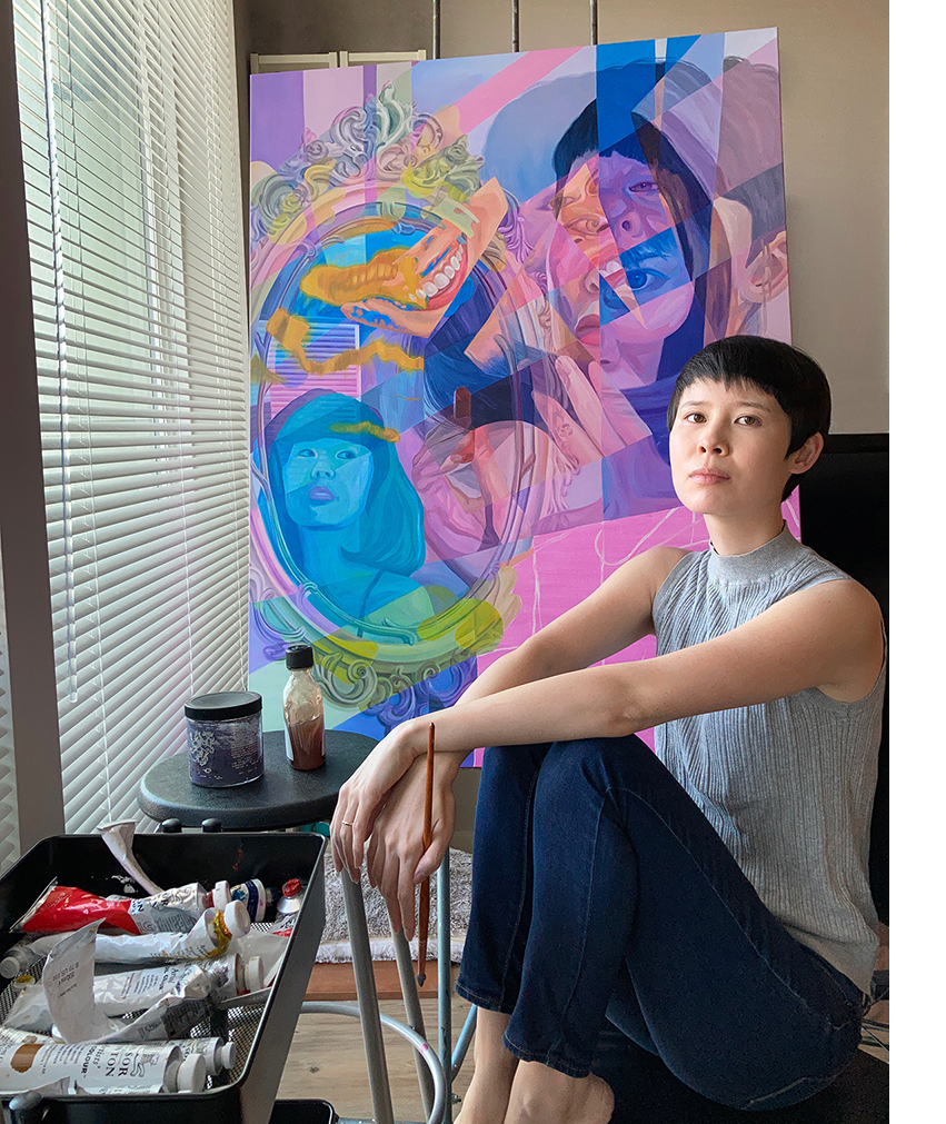 Melissa Huang poses in front of an oil painting of hers.