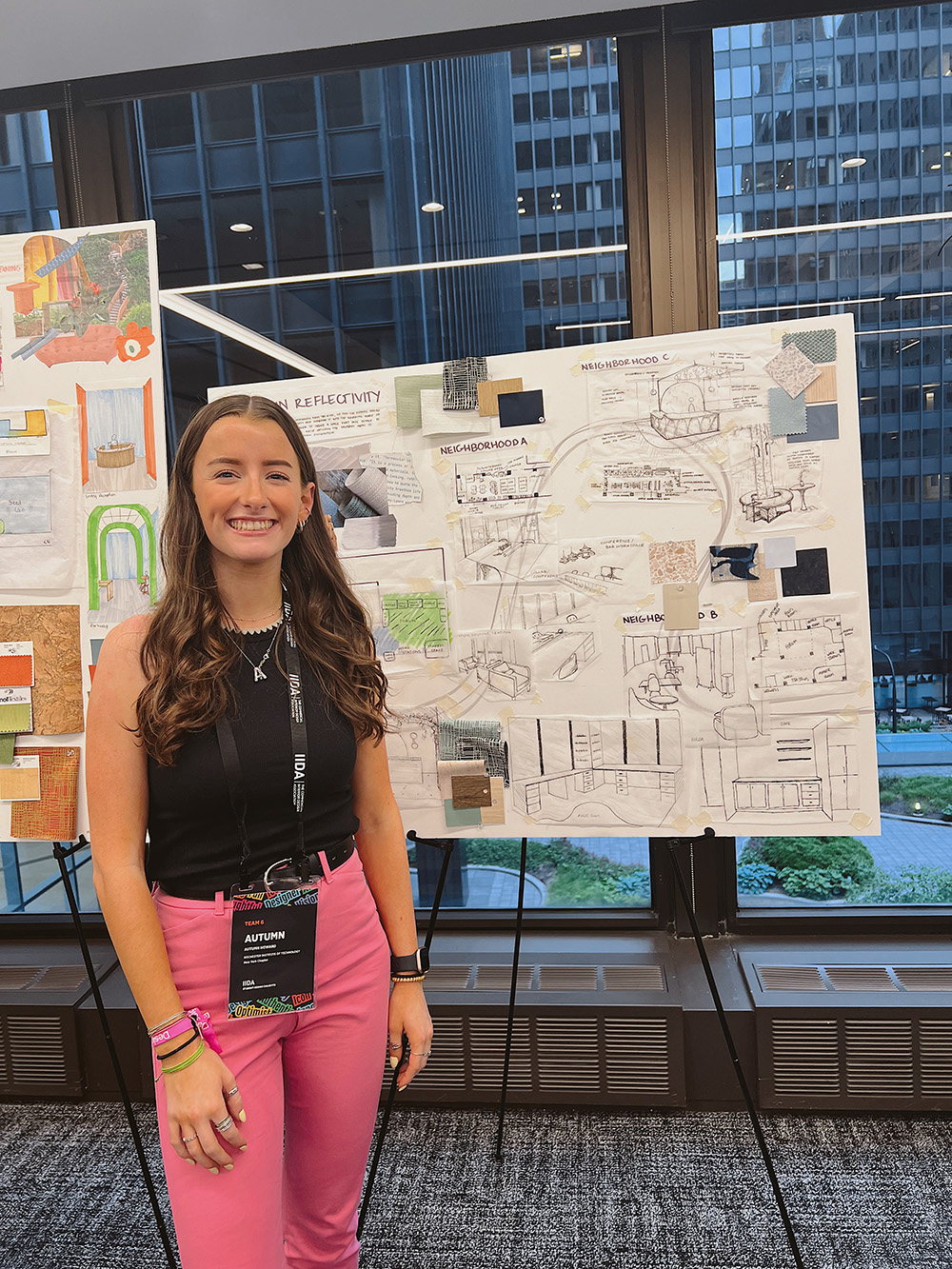 Autumn Howard stands in front of a poster board she made as part of a student charrette.
