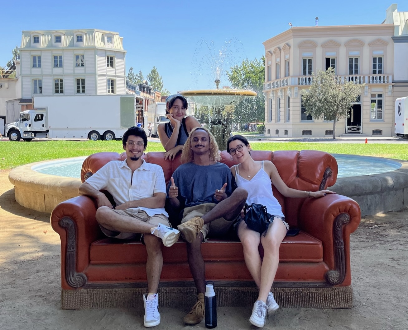 Four students sit on a couch.