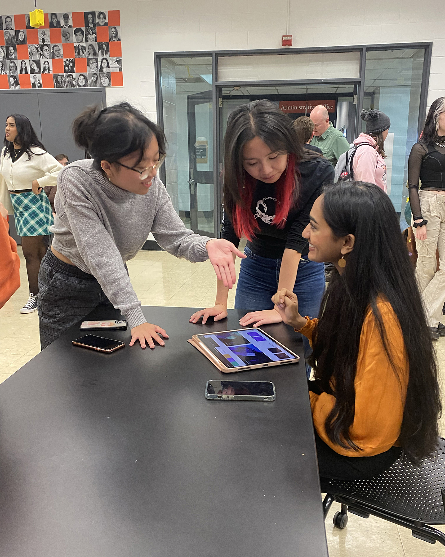 Students chat at a table.