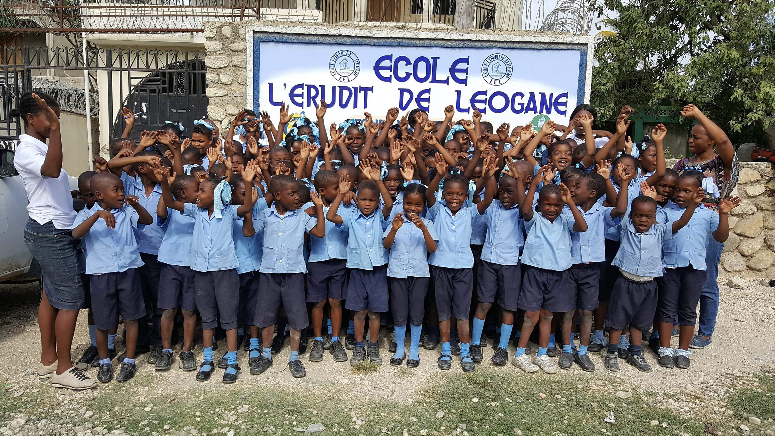 School children in uniforms take a group photo.