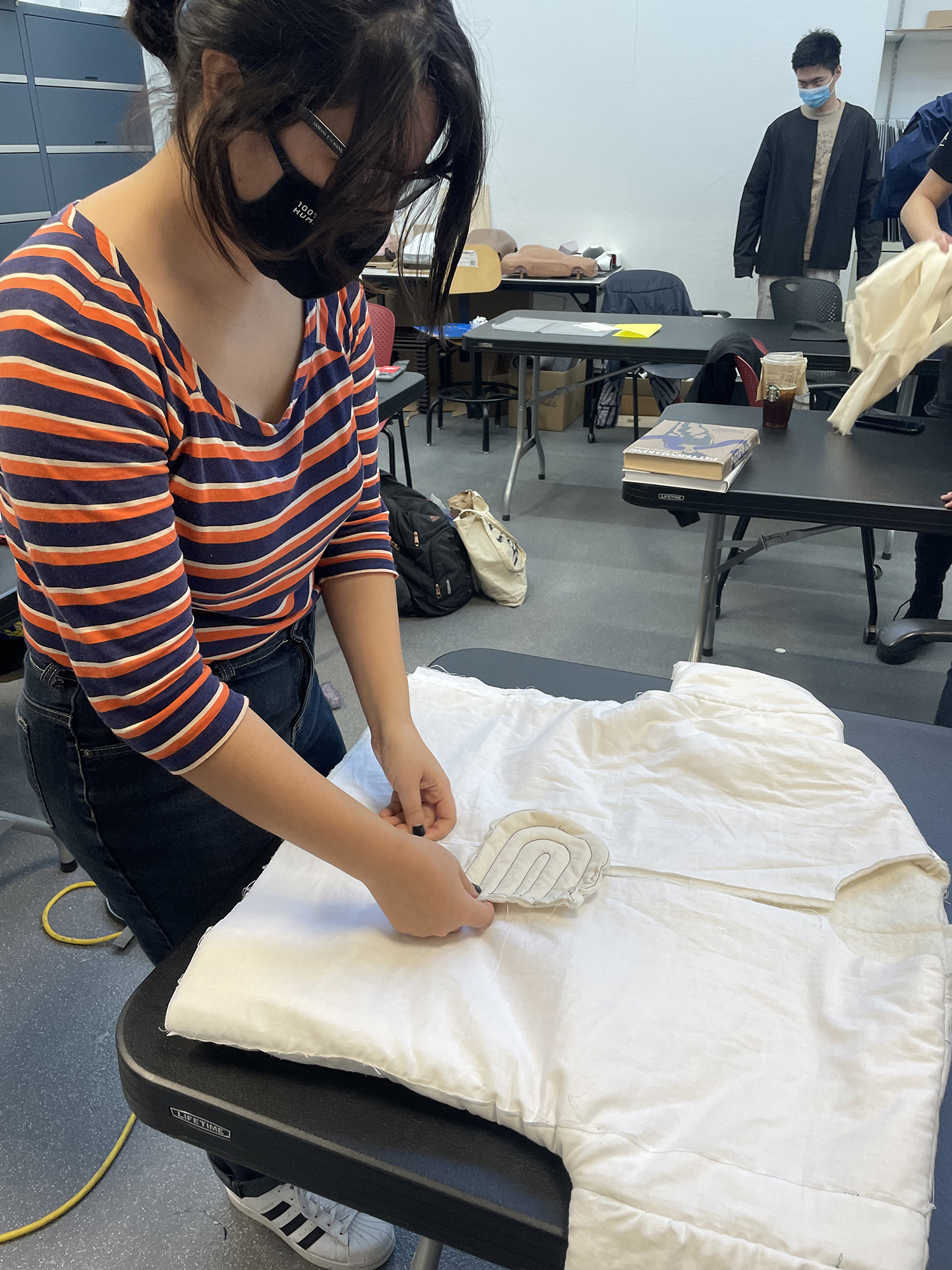 A student works with a white fabric.