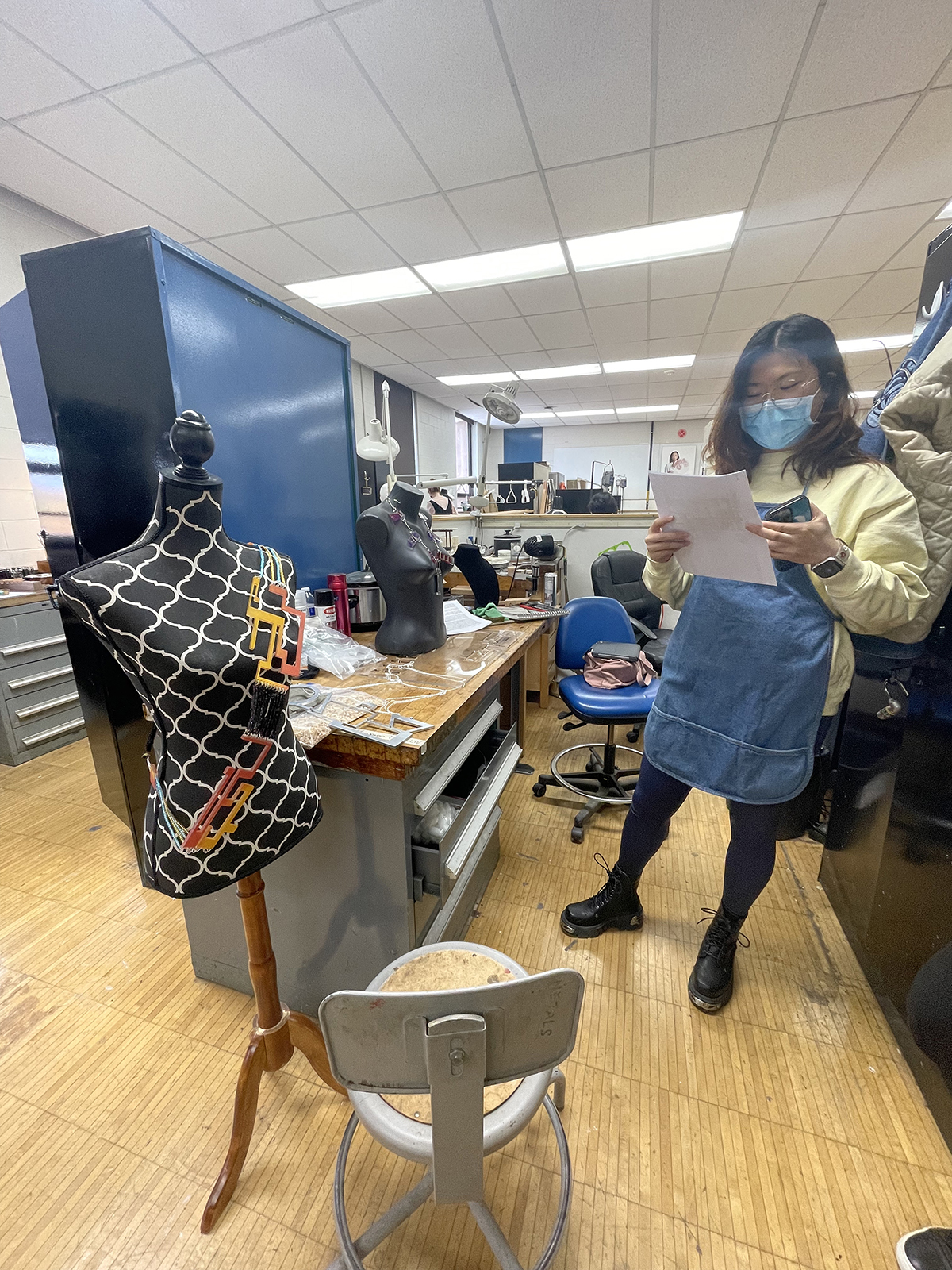 A student designs a garment in the studio.