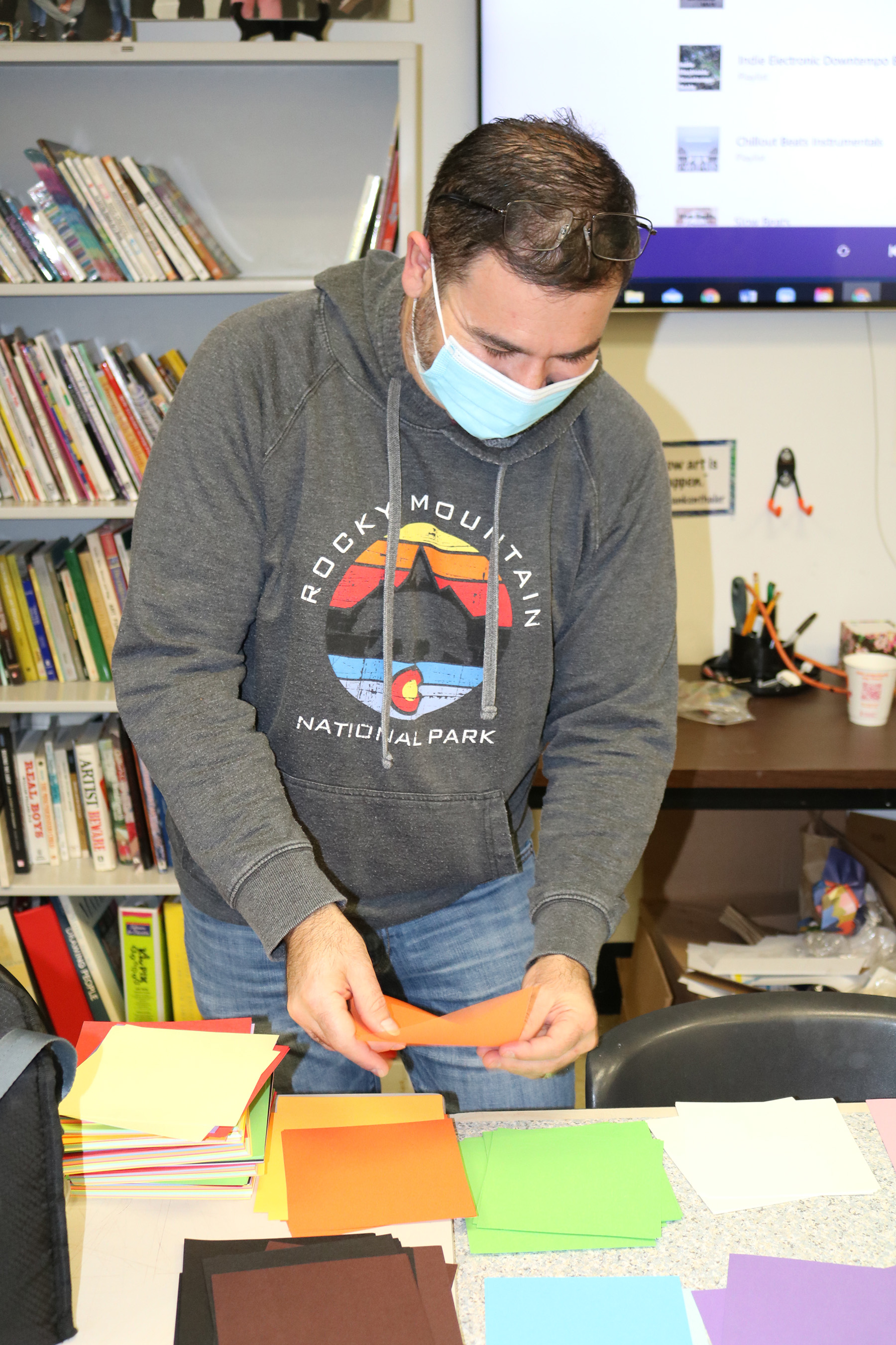 Adam Spector helps make a grab-and-go art bag full of art supplies.