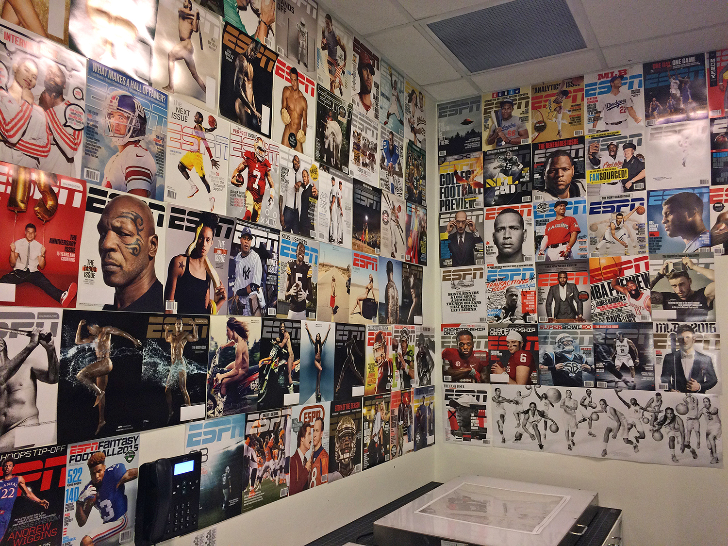 A wall covered in a large amount of magazine covers