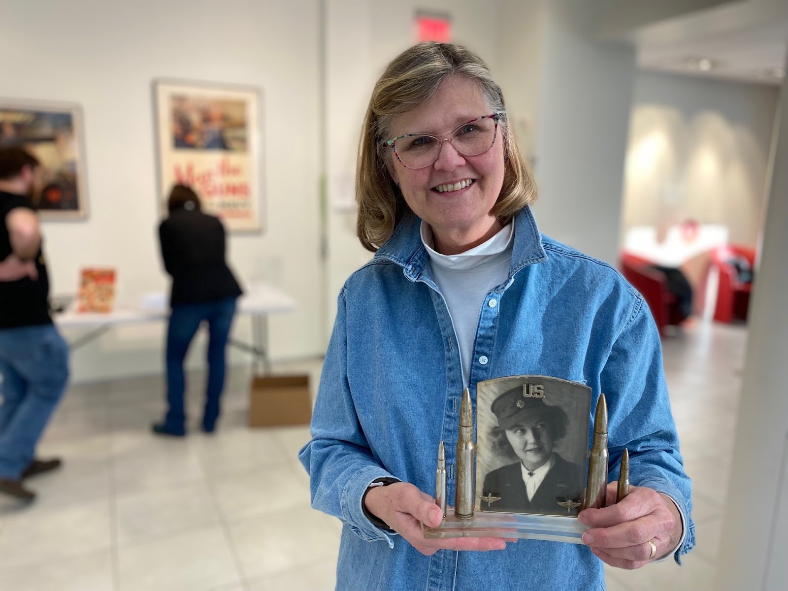 woman holding a black and white photo of her mother.