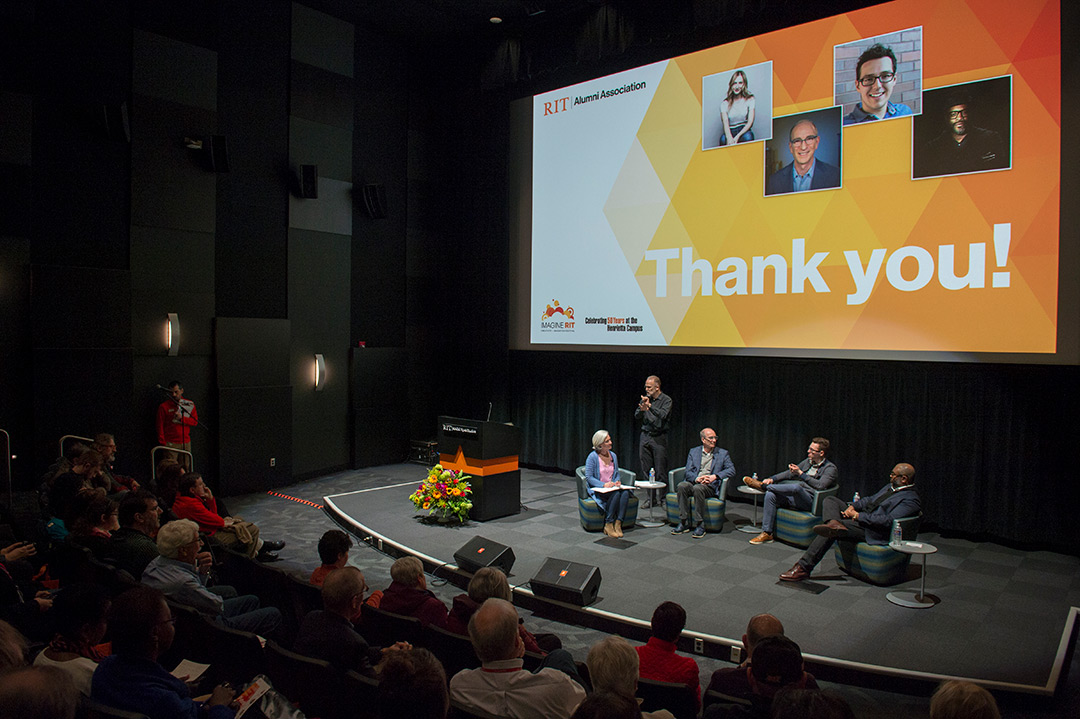 Overhead shot of four speakers on stage.