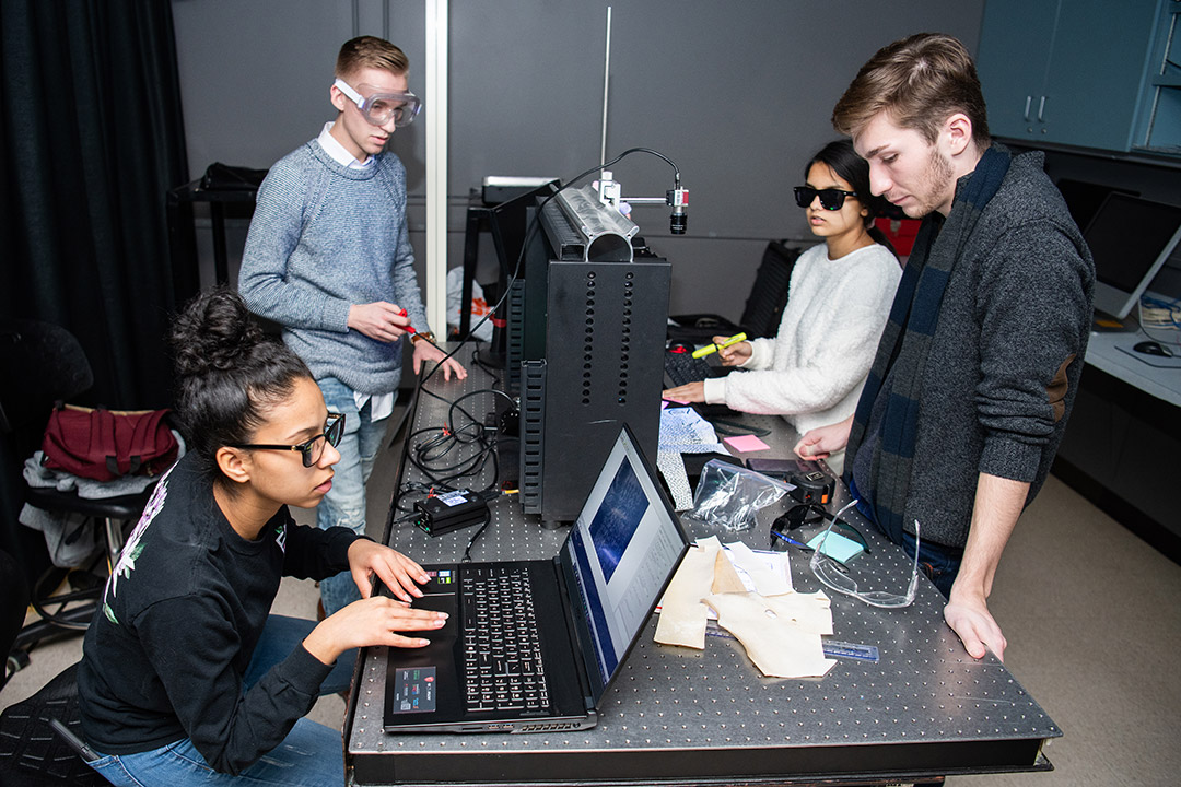 four students working on imaging device.