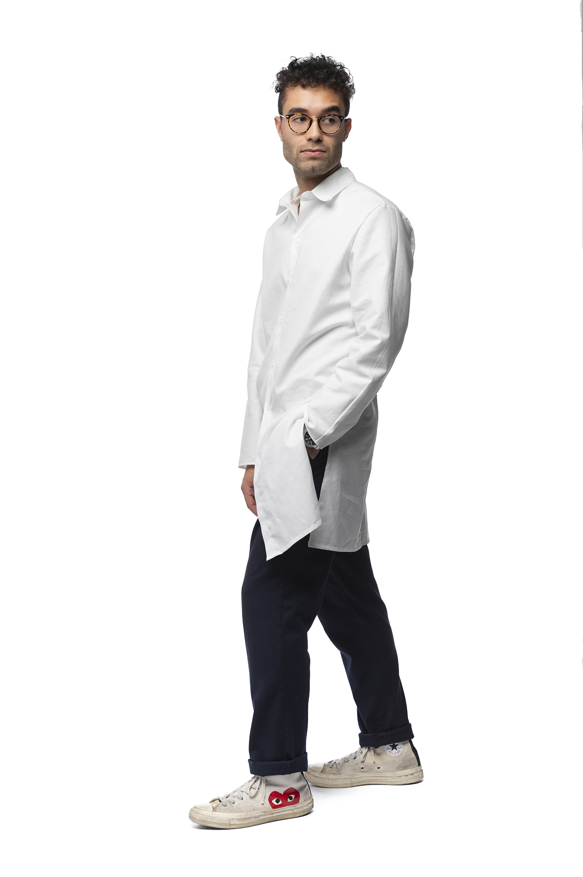 A functional clothing design of a long-sleeved, white shirt that goes down to just above the knees.