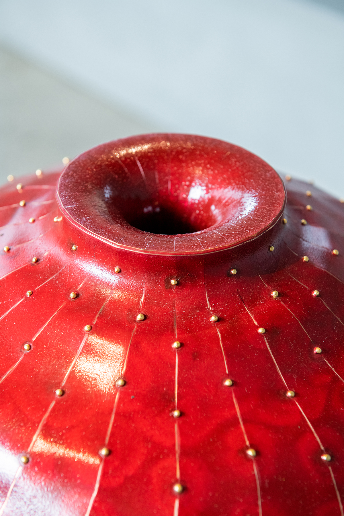 A detailed look at a red copper vessel.