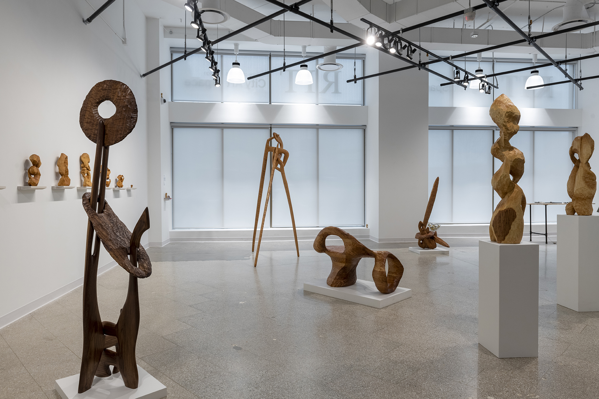 A gallery display of wooden sculptures.
