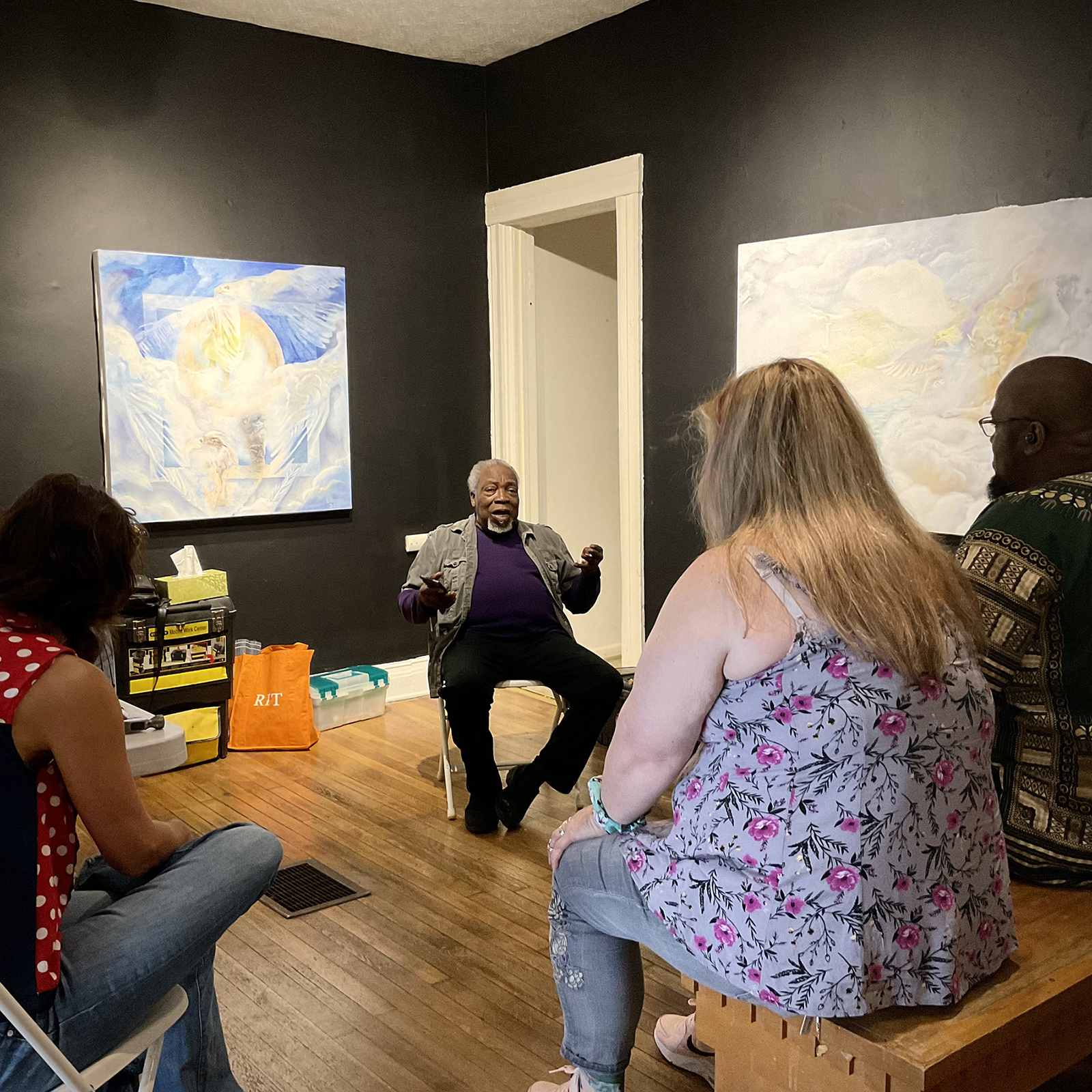 Luvon Sheppard talks with a group of people in his gallery, Joy Gallery.