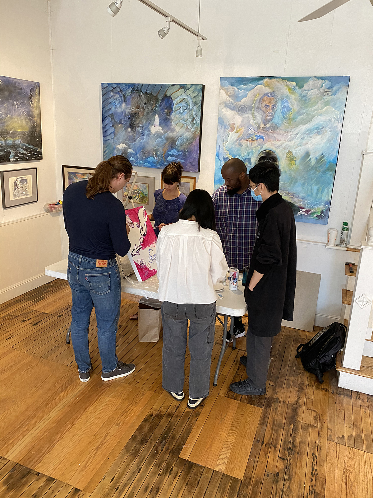 A group of artists talk inside Joy Gallery.