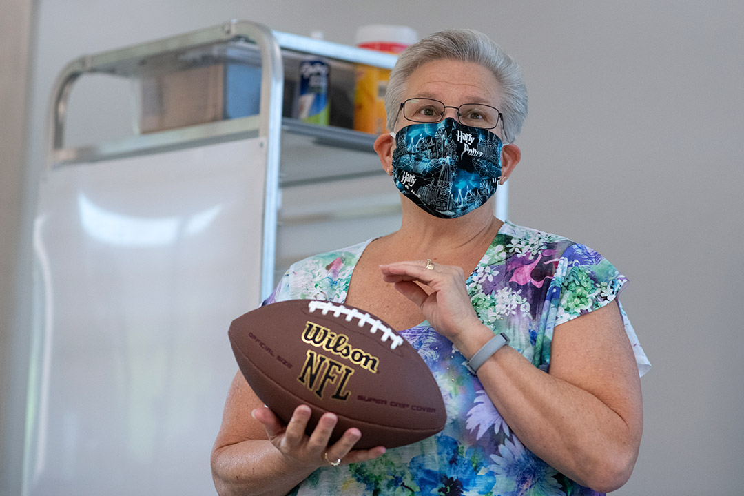 professor holding a football.