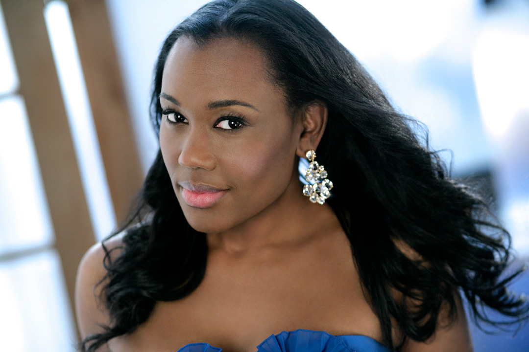 Head-and-shoulders shot of woman with long hair in ball gown