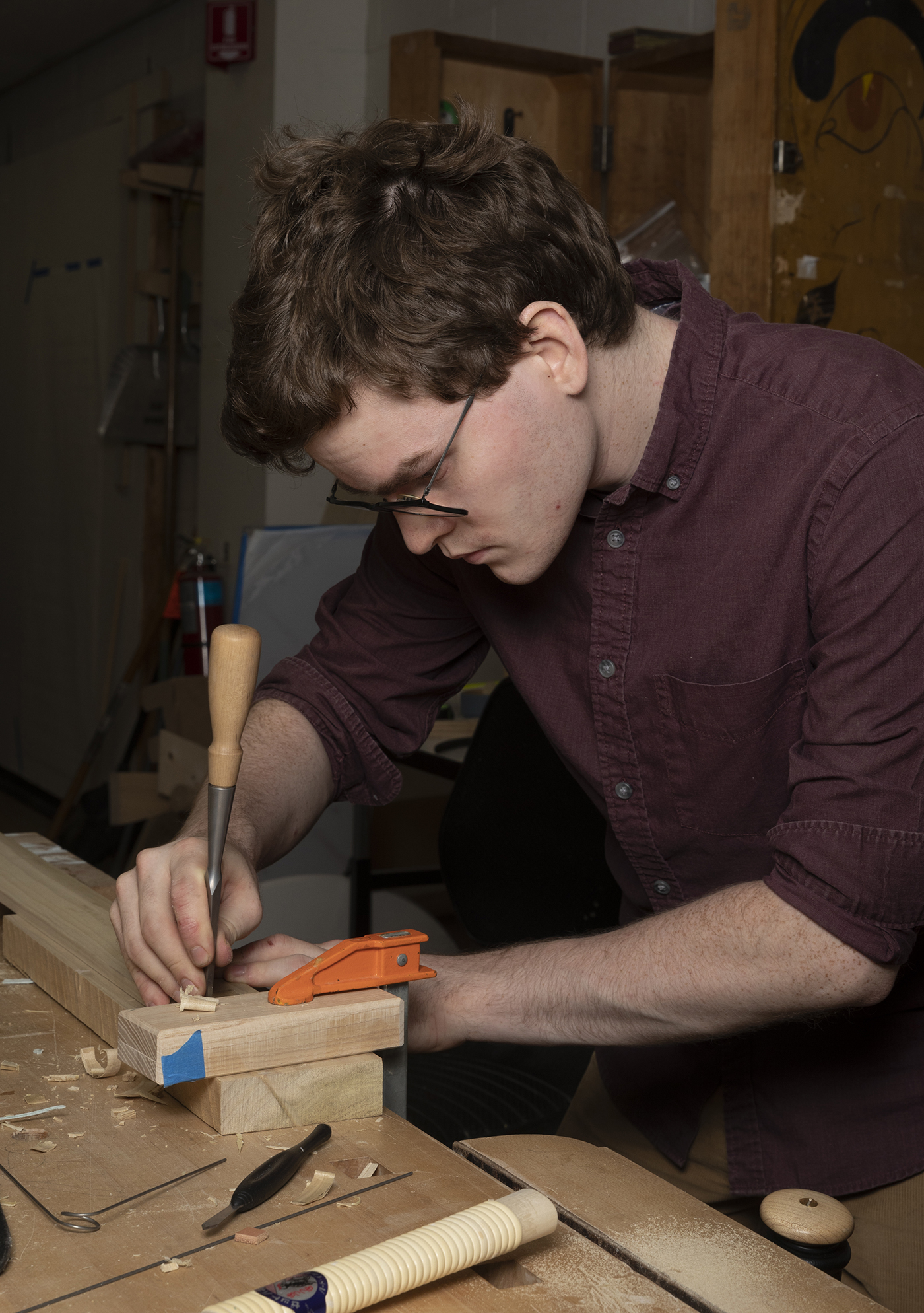 Kelly Cleveland uses a chisel in the furniture design studio.