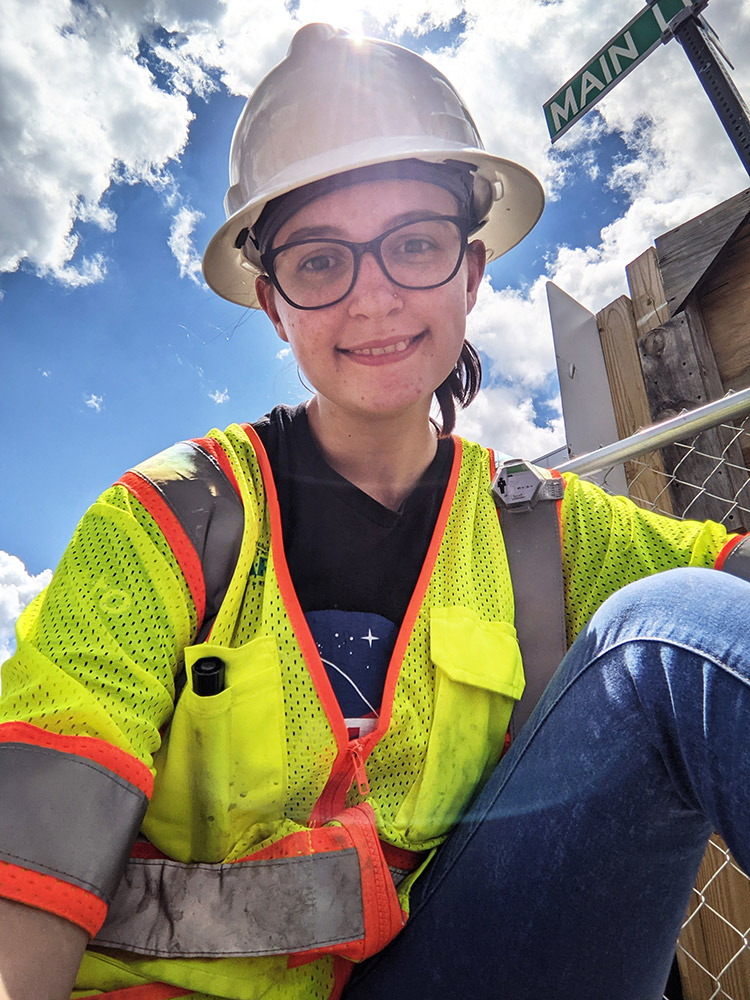 student wearing a hard hat and safety vest.