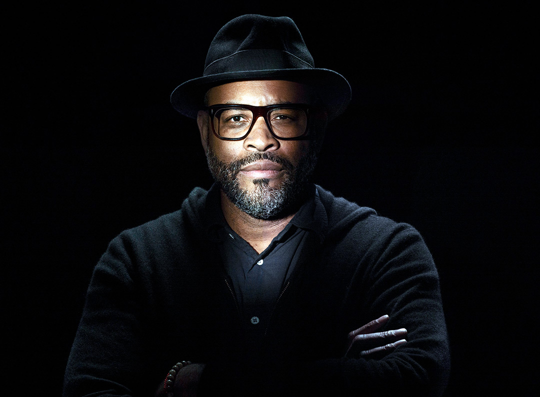 Head-and-shoulders view of man wearing black shirt and hat.