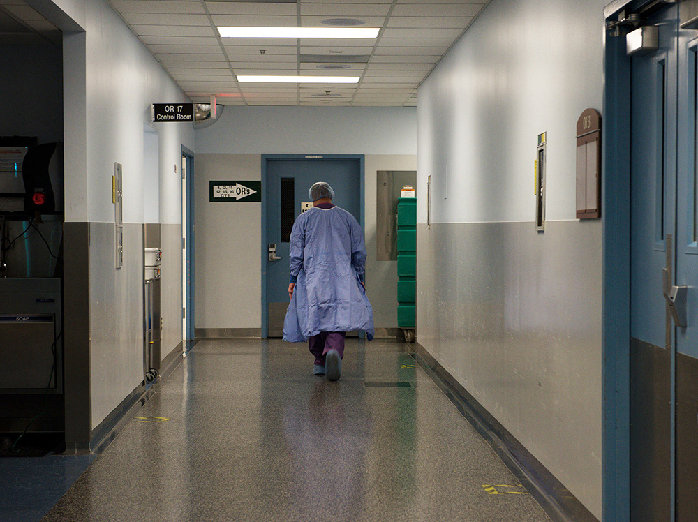 A doctor walks down the hallway