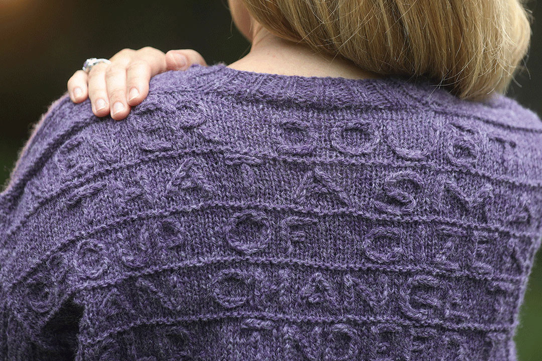 Back of knit purple sweater.