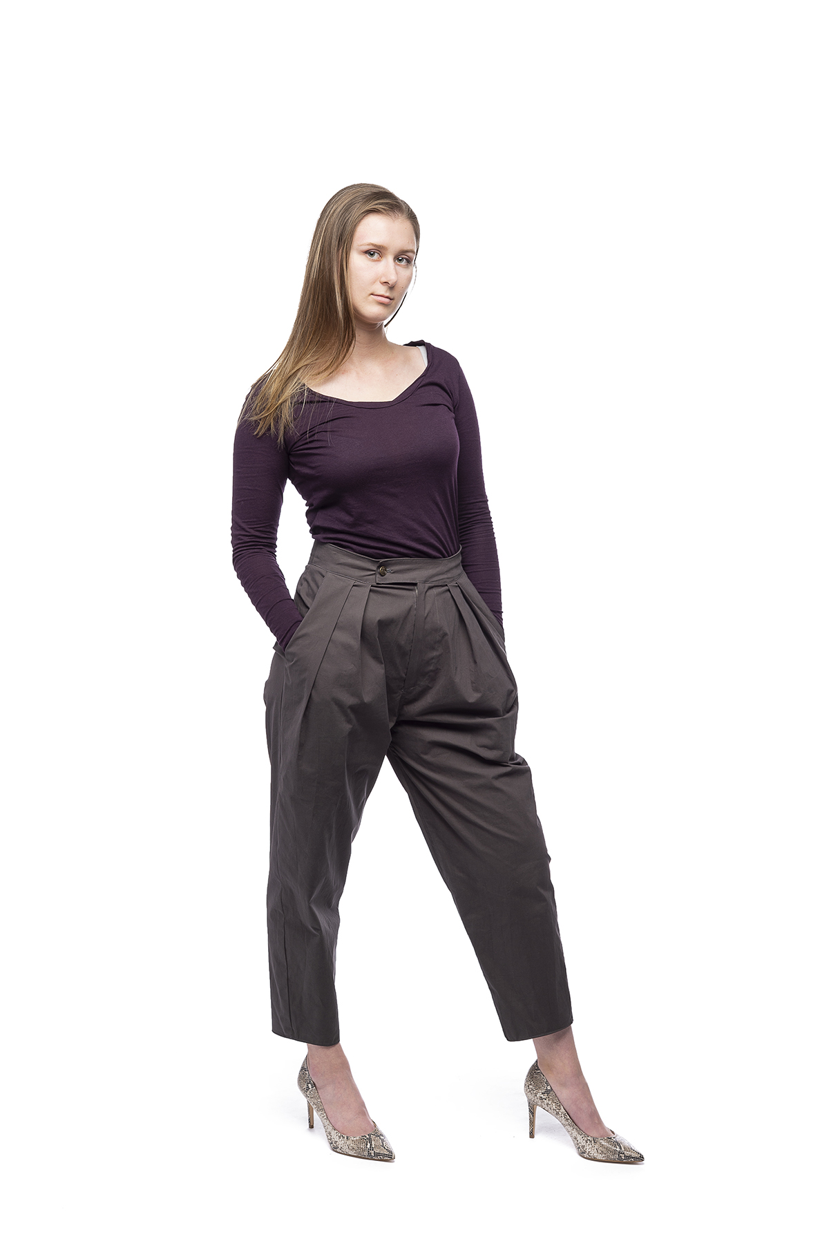 A design of a long-sleeved, dark purple top with high-rise pants and heels.