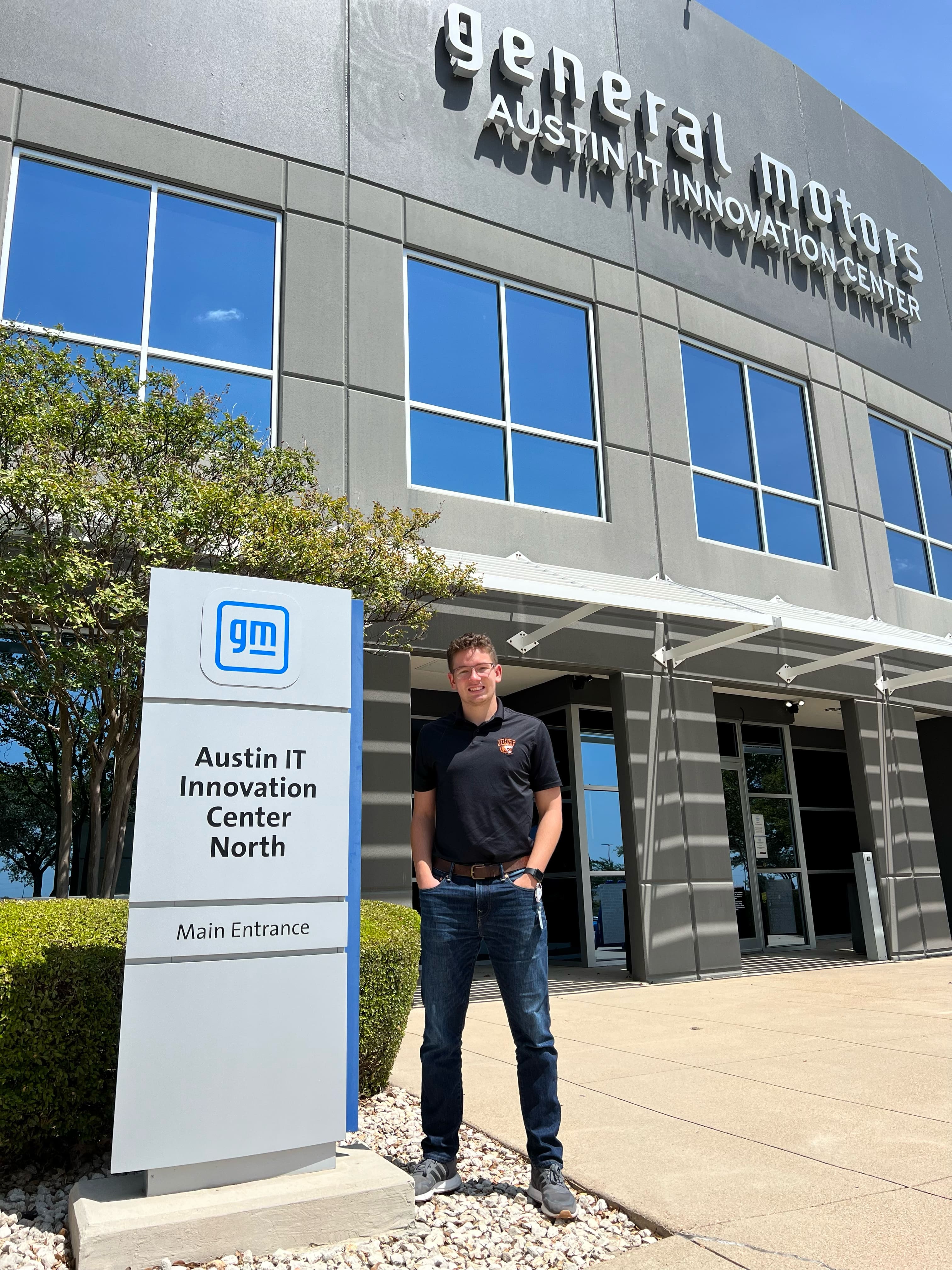 Logan Carolan standing outside GM's offices in Austin, TX.