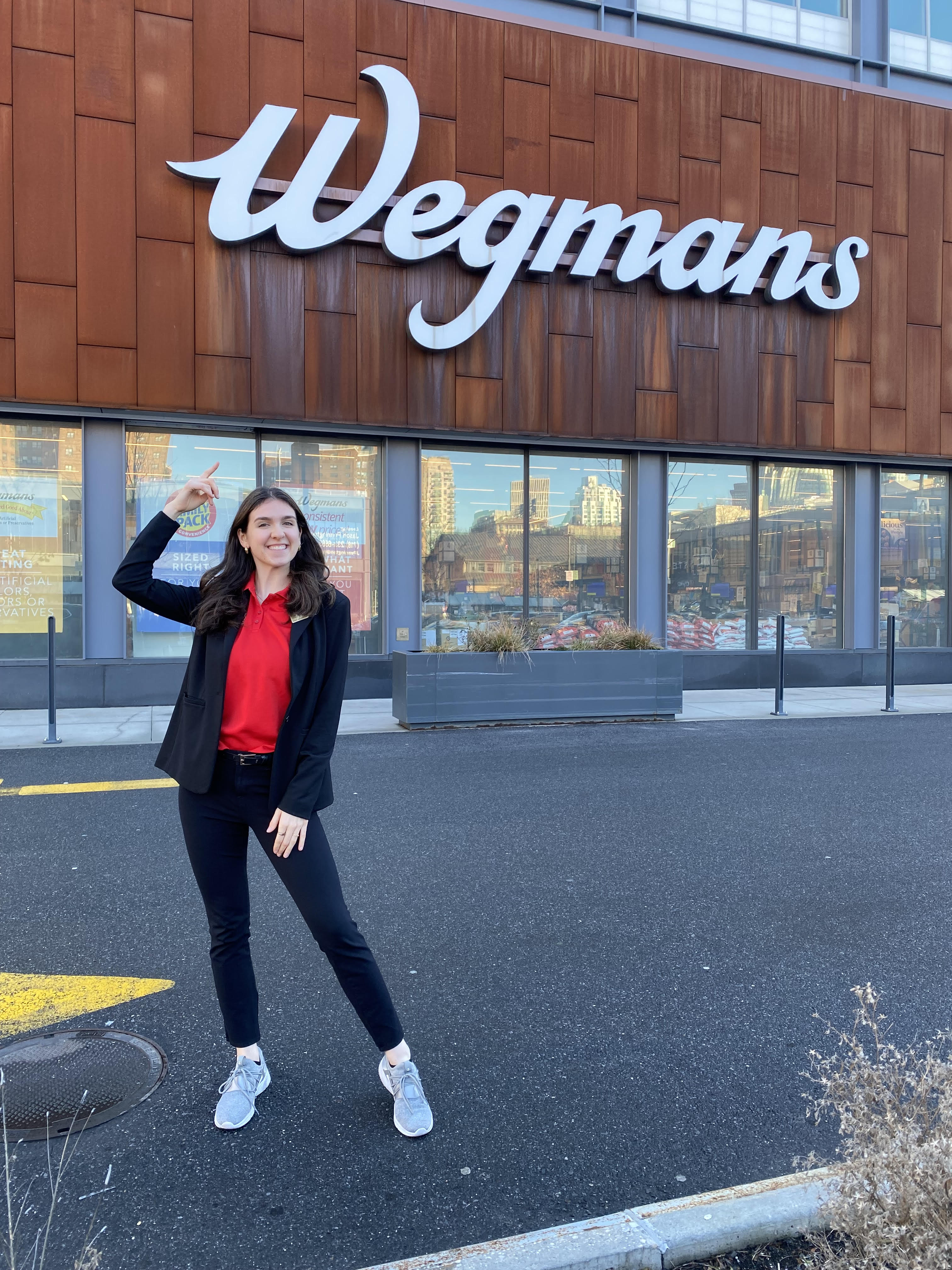Maggie Dempsey standing outside a Wegmans storefront