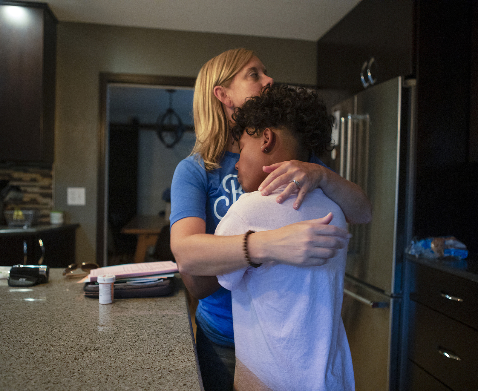 A woman and a child embrace.