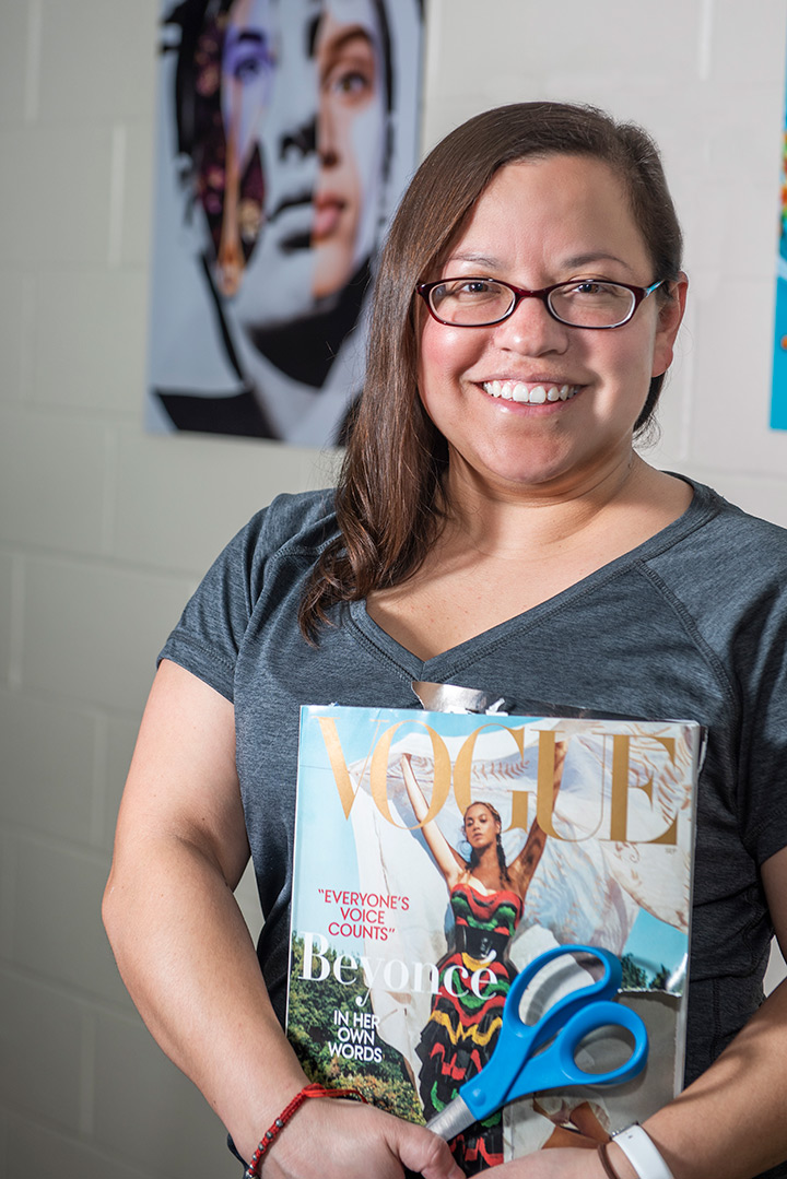 Student poses holding Vogue magazine.