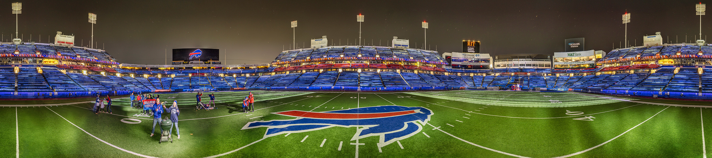 a panoramic image of Bills Highmark Stadium under the lights