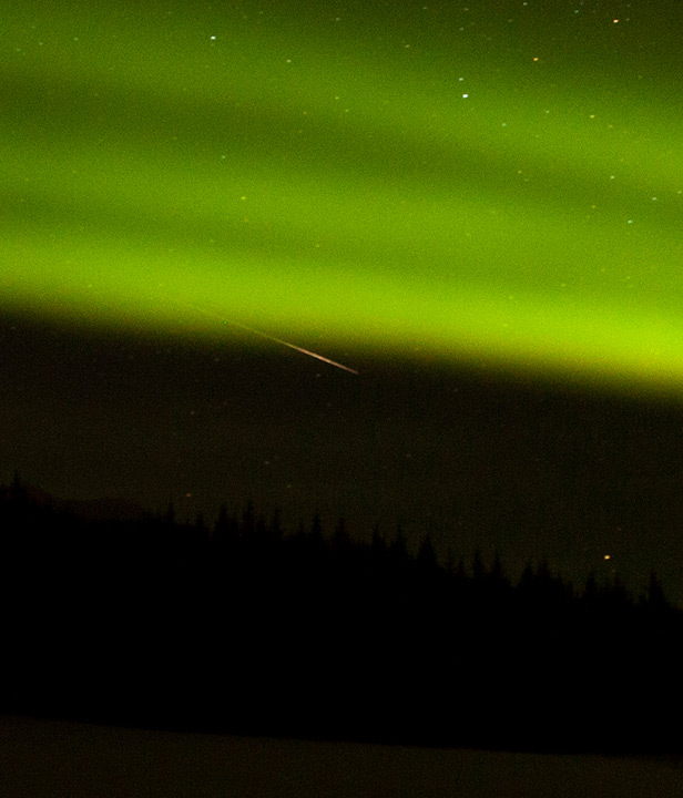 Green Northern Lights over mountains.