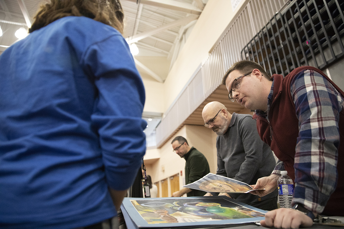 Faculty Alan Gesek reviews a portfolio.