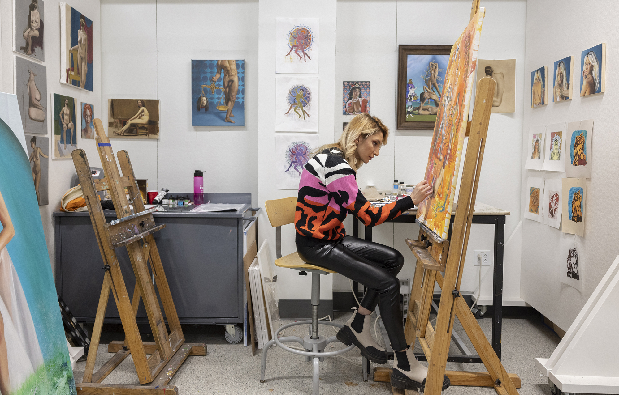 A wide view of Nava Barenji painting in an art studio.