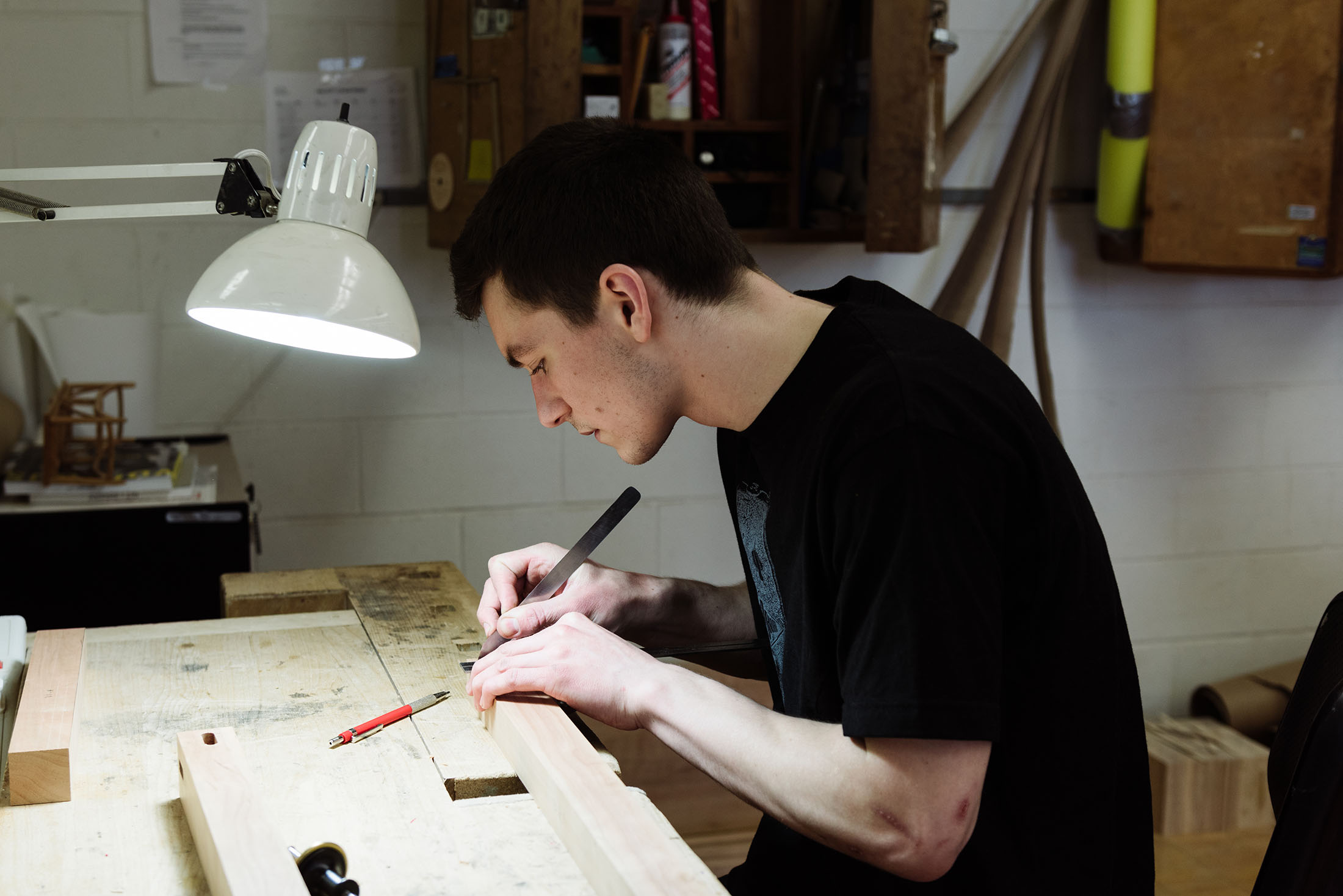 Photo by Monica Gustin: Michael Leach puts in some work in the furniture design studio. 