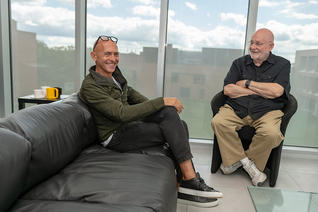 two professors sitting and talking.