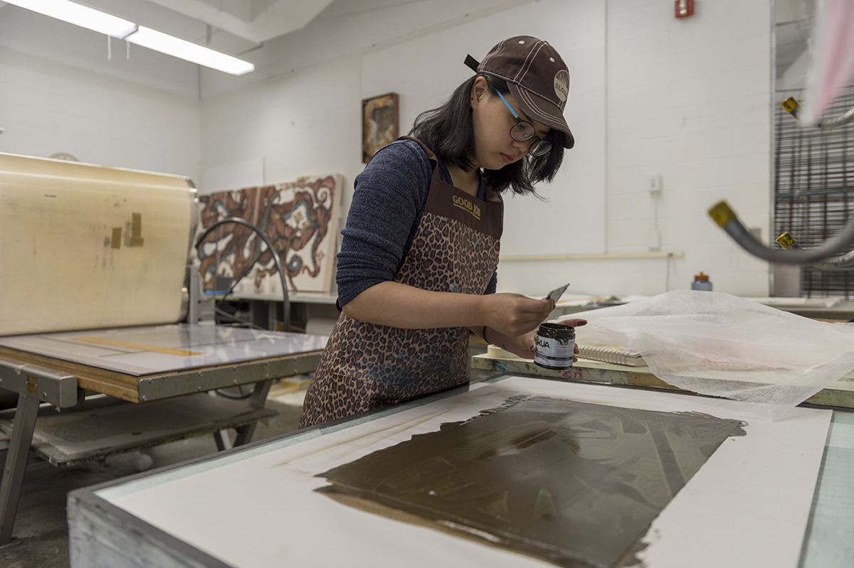 A student works in the printmaking studio