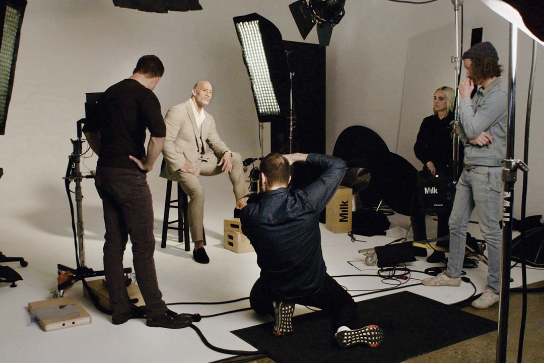 Photographer takes picture of Dwayne Johnson on photo set.