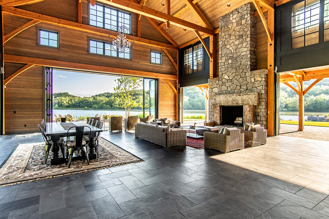 interior of home featuring open floor plan, fireplace and glass doors that open to the outside.