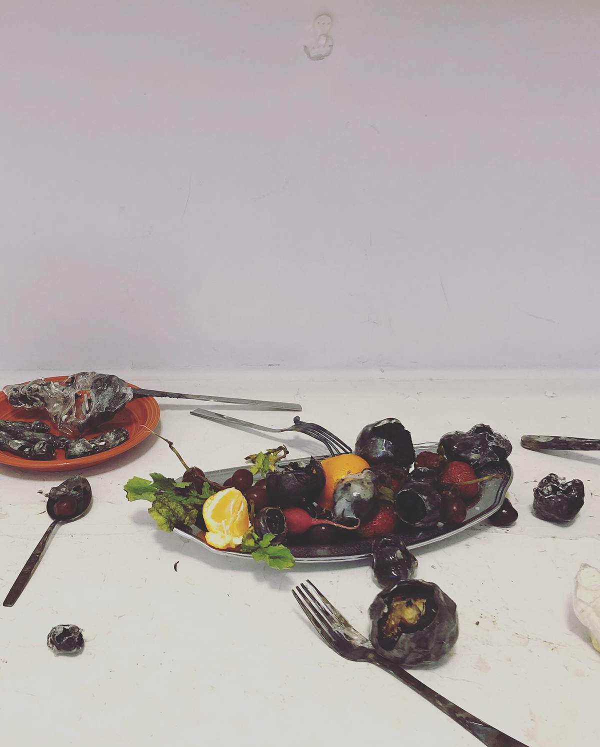 Glass fruit and silverware on a surface. This piece was exhibited at the art festival.