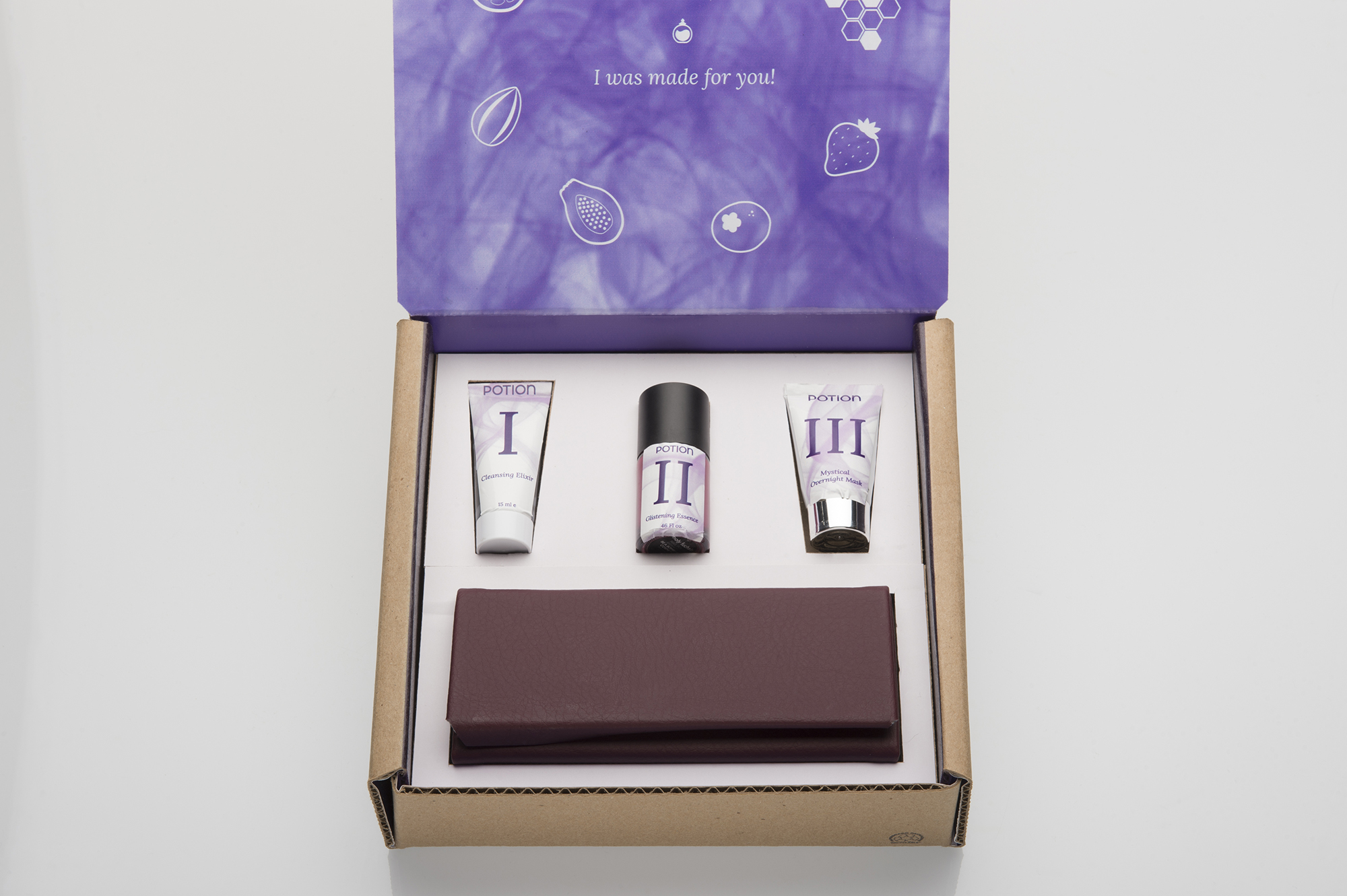 A purple and white box sits open with beauty products in it