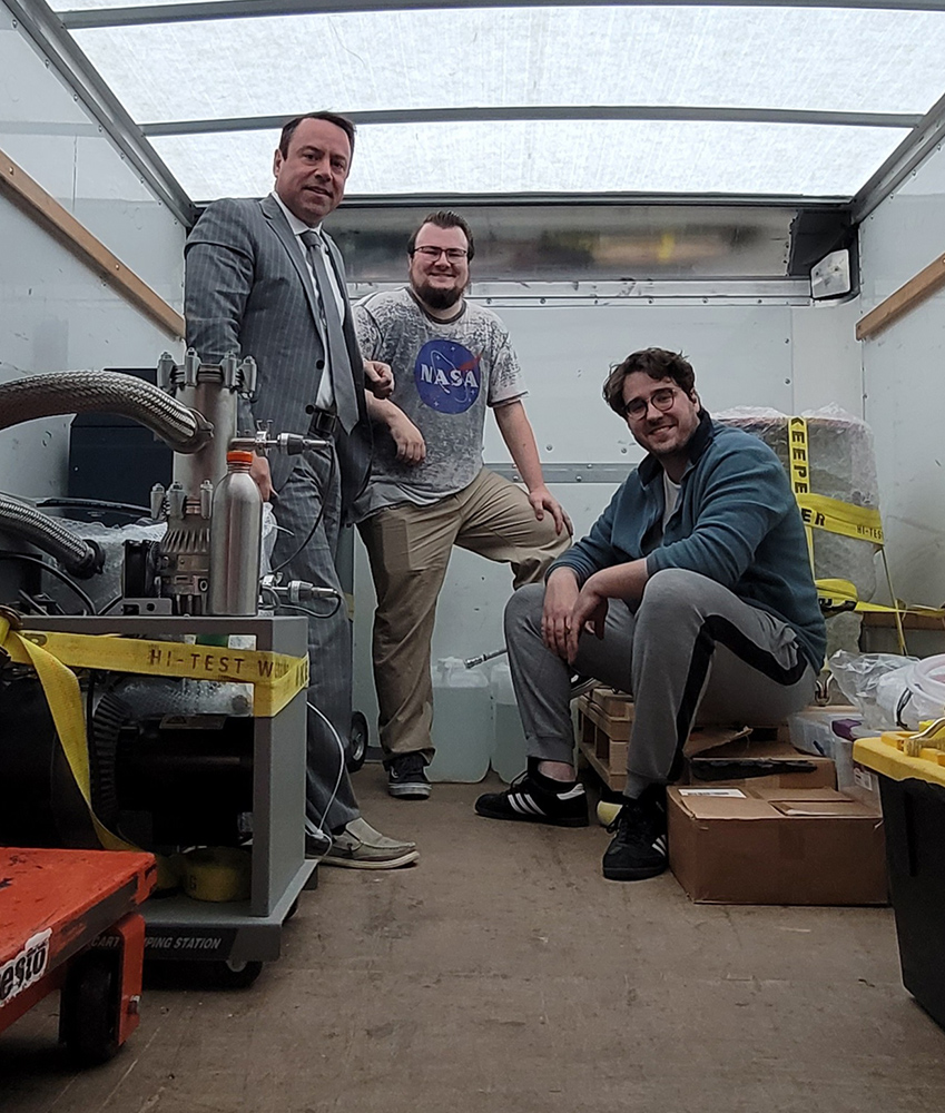 Three scientists in truck carrying equipment