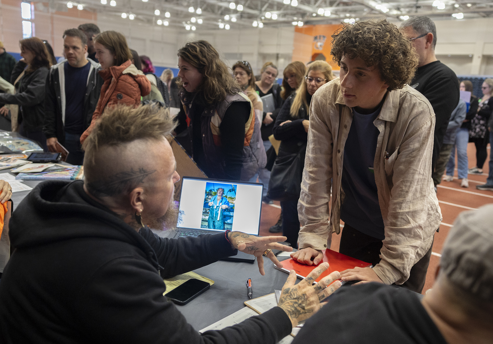 A student meets with faculty member Clay Patrick McBride.