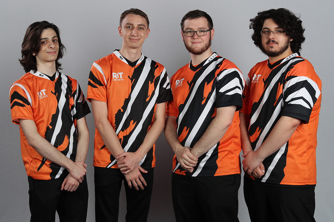 Four esports team members pose.