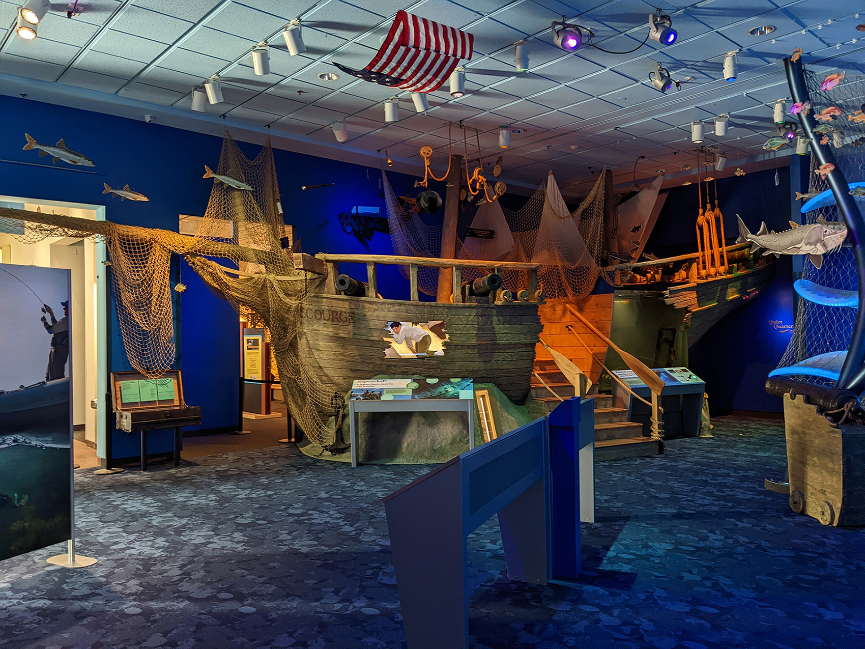 A wide view of a ship replica in the center of an exhibit.