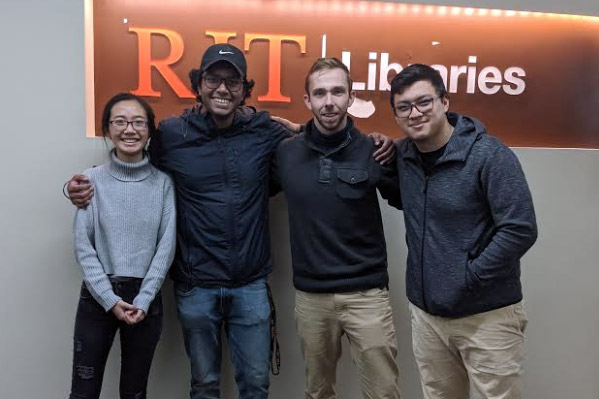 Four students standing together.