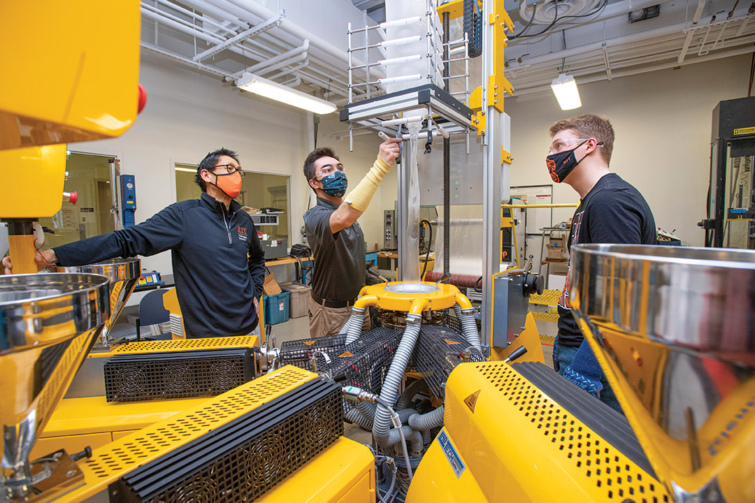 professor and students using packaging equipment.