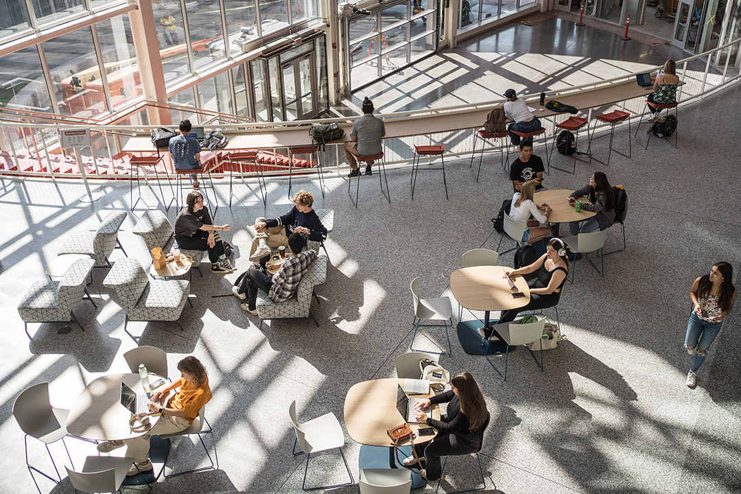 overhead view of college student sitting in a lounge area.