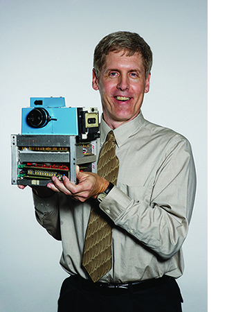 Steve Sasson holds his prototype digital camera.